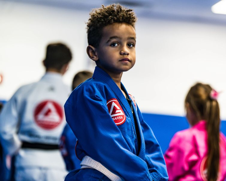 Young Gracie Barra student wearing a blue gi