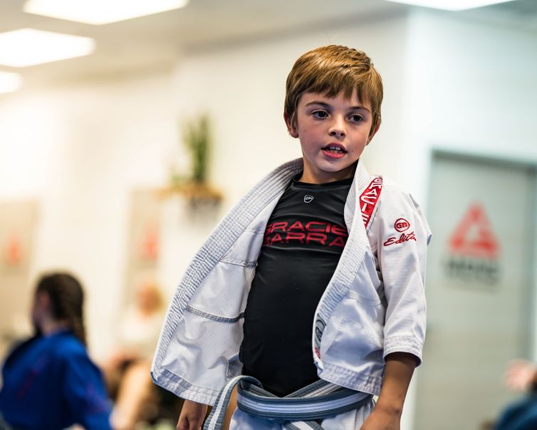 Young Gracie Barra student wearing a white gi